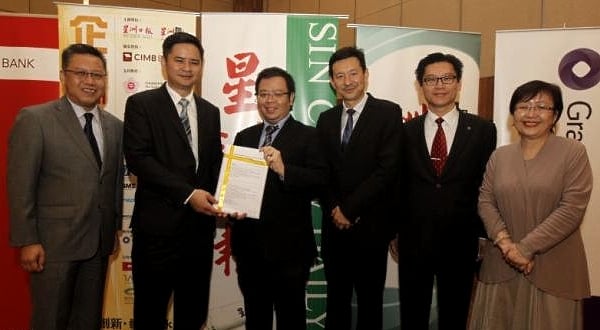MCIL Multimedia Sdn Bhd chief executive cum Sin Chew Media Corporation Berhad general manager (IT) Keu Tien Siong (L2) handing over Sin Chew Business Excellence Awards registration forms to the representative of Malaysian Retailer-Chains Association (MRCA). Photo courtesy: Sin Chew Daily