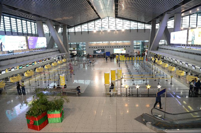 图为马尼拉国际机场空荡荡的大厅；航空人员举标语牌通知航班取消。（图：法新社）