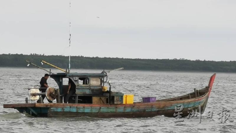 大马海事执法单位人员扣查没有执照的渔船。