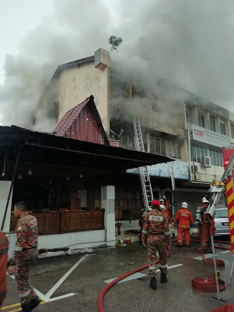 层楼店屋发生大火，滚滚浓烟冲天。