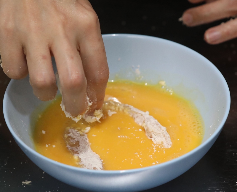 将鸡柳依次沾上面粉、鸡蛋及面包糠。