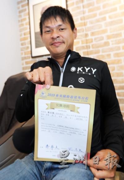 曾志龙手握2019东吴国际超级马拉松赛的完赛证书。
