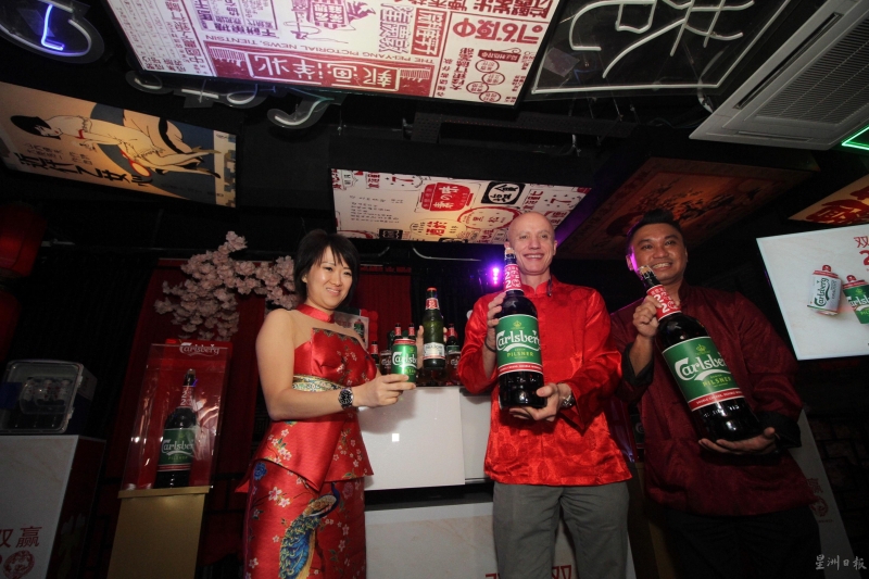 赖明珠（左起）、 葛利尼、朱泽豪展示普通瓶装和限量版3升装的巨型瓶装酒。