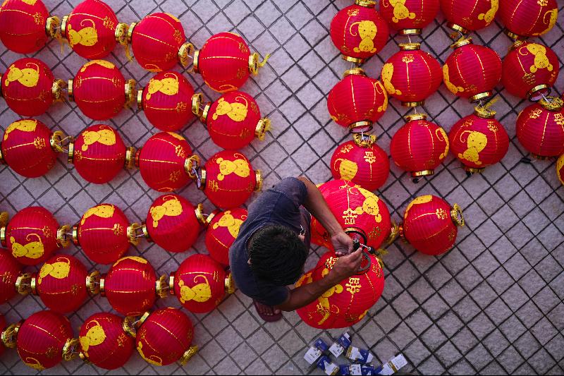 A worker installs traditional Chinese lantern decorations at Thean Hou Temple in Kuala Lumpur ahead of the Lunar New Year. Photo courtesy: AFP