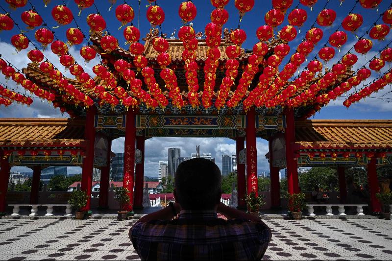 A man prays under traditional Chinese lantern decorations at Thean Hou Temple in Kuala Lumpur ahead of the Lunar New Year. Photo courtesy: AFP