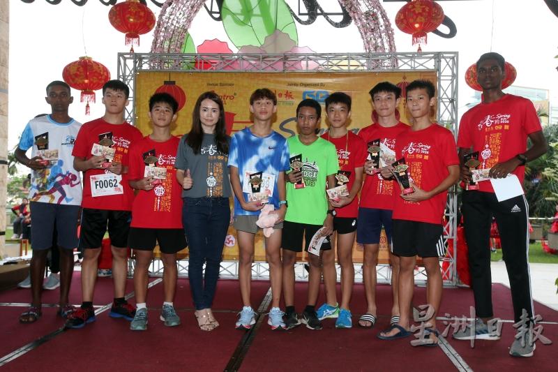 李美玲（左四）颁发奖品予在男生组（10至17岁）获胜的优胜者。（图：星洲日报）