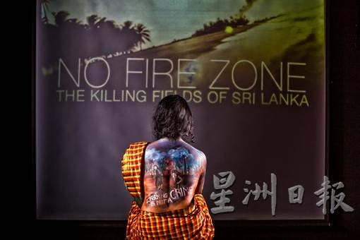Ruby (R) paint the scenes of massacre on the back of Indrani Kopal plus a message Ruby (R) paint the scenes of massacre on the back of Indrani Kopal plus a message
