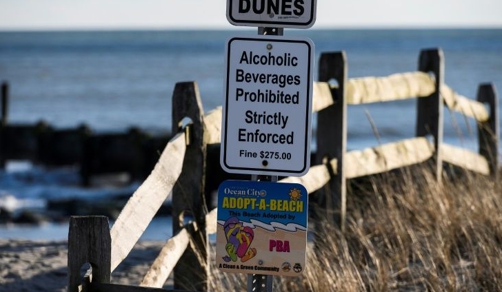 A sign on the Ocean City boardwalk warns against drinking alcohol on the beach. Photo courtesy: AFP