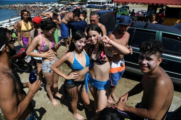 Teenagers pose at Bahia de los Ninos beach in La Guaira. Photo courtesy: AFP