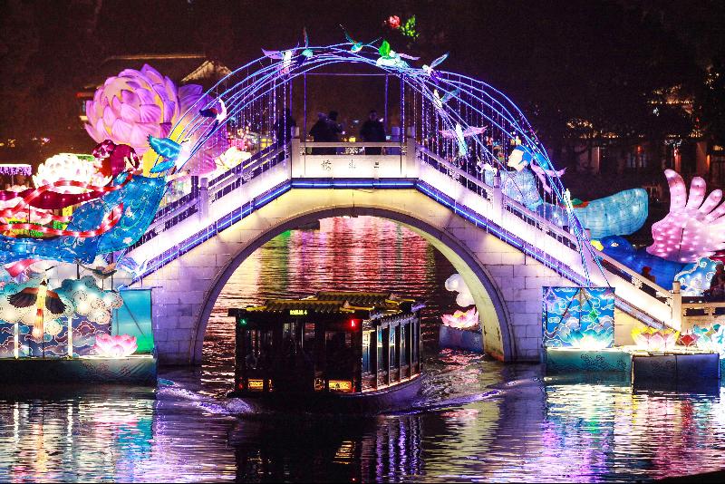 A boat making its way past a bridge at a lantern show in Nanjing, China, ahead of the Lunar New Year of the Rat. AFP
