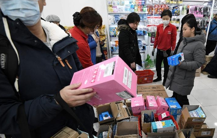 Tourists buy face masks at a shop in the Myeongdong shopping district in Seoul. AFP Tourists buy face masks at a shop in the Myeongdong shopping district in Seoul. AFP