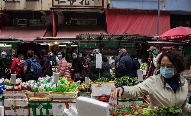 People wearing masks visit a fresh food market in Hong Kong. AFP People wearing masks visit a fresh food market in Hong Kong. AFP