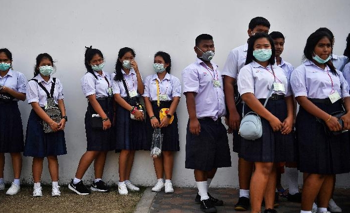 Thai students donning face masks line up in front of the Grand Palace in Bangkok. AFP Thai students donning face masks line up in front of the Grand Palace in Bangkok. AFP