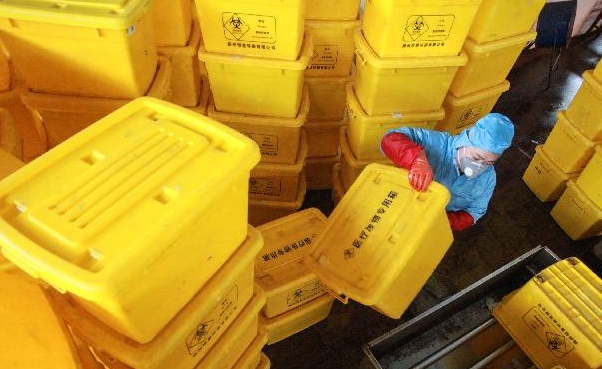 A staff member in protective clothing cleans containers used to transport medical waste at a medical waste treatment plant in Yangzhou in China's eastern Jiangsu province. AFP A staff member in protective clothing cleans containers used to transport medical waste at a medical waste treatment plant in Yangzhou in China's eastern Jiangsu province. AFP