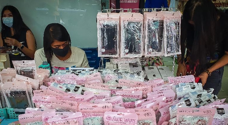 A woman looks through face masks on sale at a roadside stall in Bangkok. AFP A woman looks through face masks on sale at a roadside stall in Bangkok. AFP