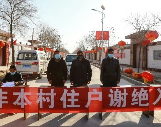 An unofficial checkpoint stops outsiders getting into Zhangye in Gansu province. AFP An unofficial checkpoint stops outsiders getting into Zhangye in Gansu province. AFP