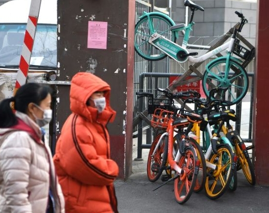 Bicycles bar the entrance to an apartment block in Beijing as residents seek to keep control of who can enter. AFP Bicycles bar the entrance to an apartment block in Beijing as residents seek to keep control of who can enter. AFP