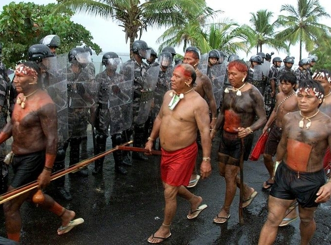 Members of the Yanomami tribe walked past military police in April 2000 in Coroa Vermelha, as they gather for protests to coincide with the 500th anniversary of the arrival of Portuguese explorers. AFP
