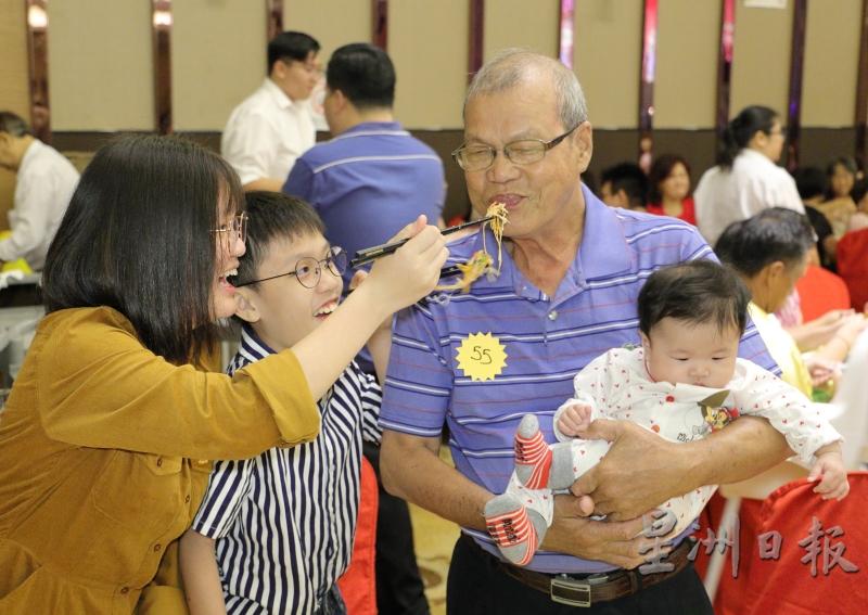 老宝宝梁育华享受晚辈们的喂食。（图：星洲日报）