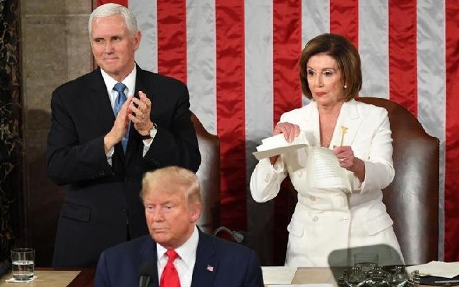 Vice President Mike Pence claps as House of Representatives Speaker Nancy Pelosi rips a copy of Trump's speech after he delivers the State of the Union address at the US Capitol. AFP