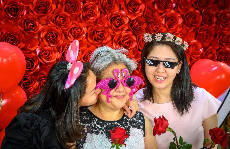 People pose for photos on Valentine's Day in an improvised studio in a food store in Bangkok. AFP