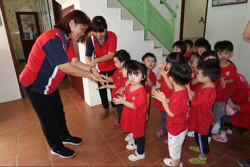 教师给园生洗手液，让他们用正确的方式搓揉。图为新福源堂幼儿园园长林楠恩（左）教导园生如何正确搓揉双手。