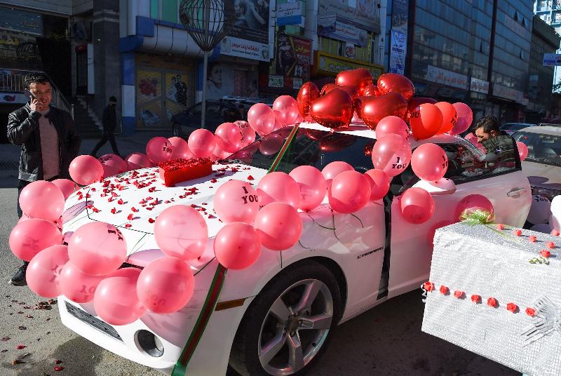 A vendor decorates a car with balloons on Valentine's Day in Kabul, Afghanistan. AFP