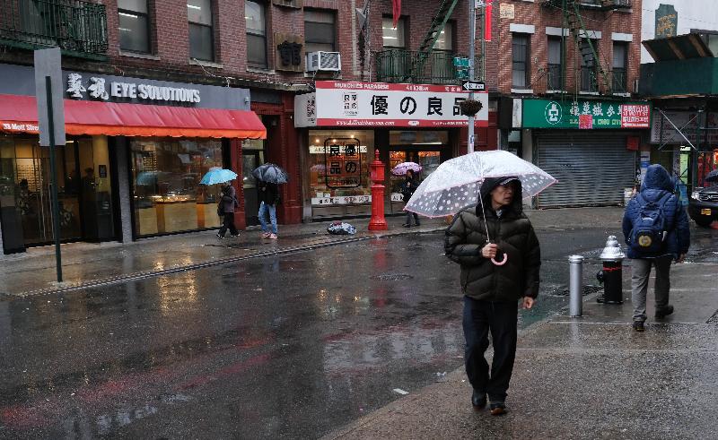 People walk in New York's Chinatown where business revenues are down around 40% over fears of COVID-19. AFP