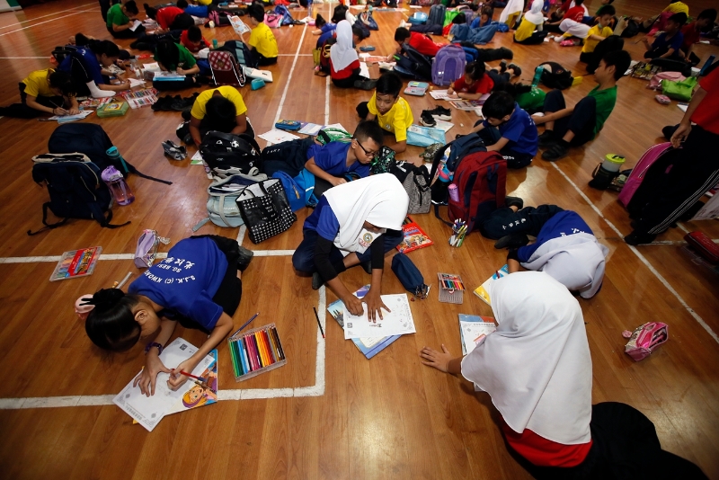 学生们十分专注地绘画，把心目中的传统节日挥洒在画纸上。