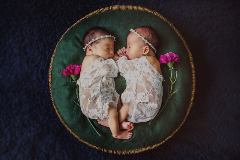 一对新生的双胞胎宝宝相互依偎睡着，画面宁静又唯美。（受访者提供）