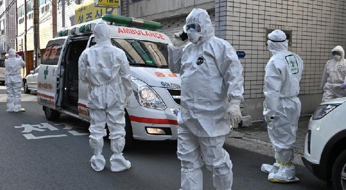 Medical workers in protective gear visit the residence of people with suspected coronavirus symptoms near the Daegu branch of Shincheonji Church of Jesus. AFP Medical workers in protective gear visit the residence of people with suspected coronavirus symptoms near the Daegu branch of Shincheonji Church of Jesus. AFP