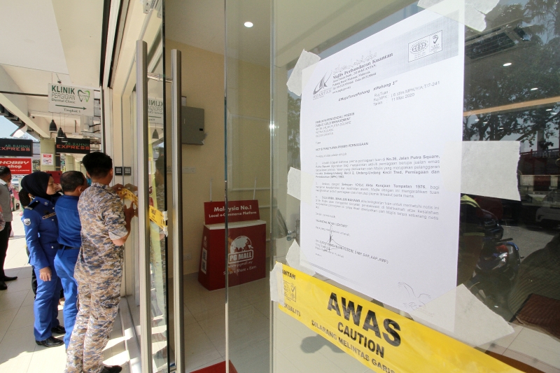 关丹市议会执法队在店铺门口贴上告示并拉上封锁条，即时禁止业者营业。