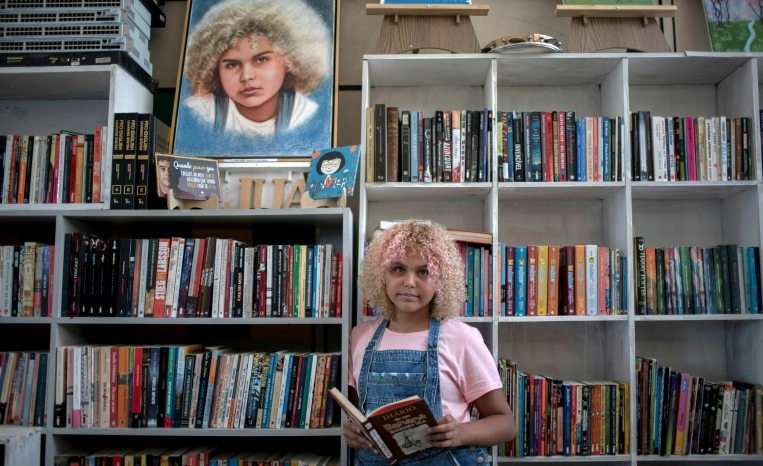 After Lua Oliveira's call for books went viral, she has been receiving around 1,500 a week, way more than her small library can hold. AFP