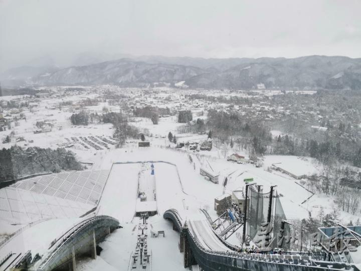 到达跳台滑雪竞技场顶部，迎著飕飕冷风，远眺一望无际的雪景，近看选手们练习刺激的跳跃。

