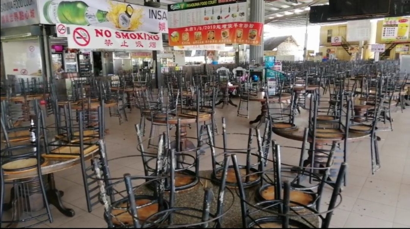 大山脚甘榜峇鲁点心城的熟食摊贩照常营业，不过，业者为了避免违反禁令，把椅子都倒叠在桌子上。