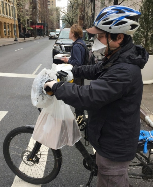 Many New York delivery men wear gloves and masks, while some have even taken to wrapping plastic bags around the handlebars of their bikes. AFP