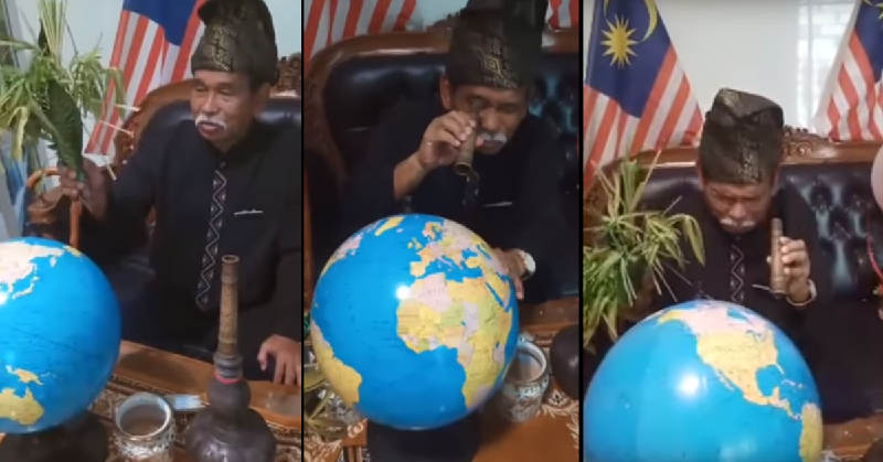 巫师王在地球仪前右手撒黄米，左手持班兰叶洒净，为马来西亚建立保护圈，避免遭到病毒侵害。（视频截图）