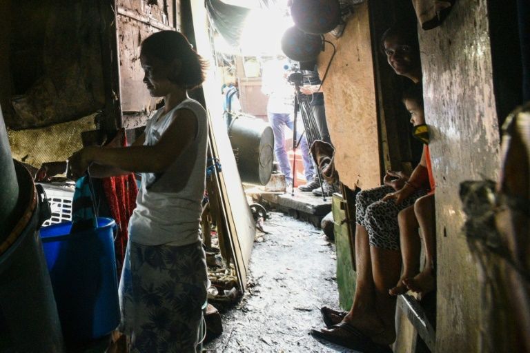 Homes in these slums are tightly-packed, tiny spaces that are only big enough for sleeping lack running water. AFP