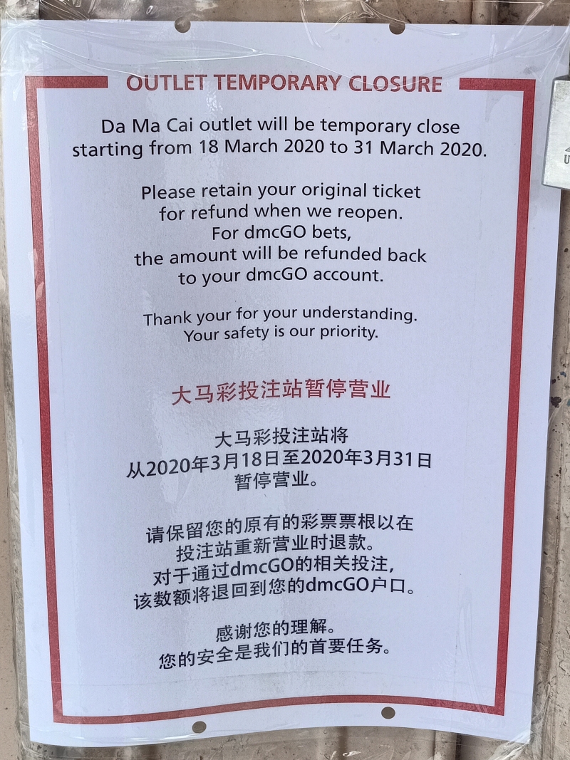 庇朥大马彩博彩投注站的门口张贴一张暂停营业的通告。