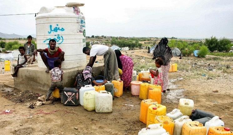 People load up on water from a cistern at a makeshift camp for displaced Yemenis in northern Hajjah province. AFP