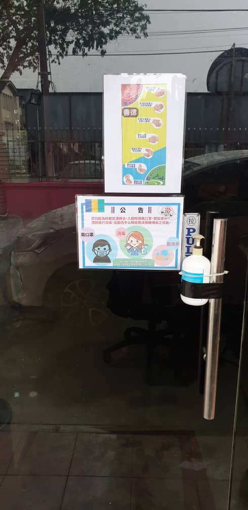 善德儿童福利之家在门上张贴公告，并提供消毒搓手液供使用。