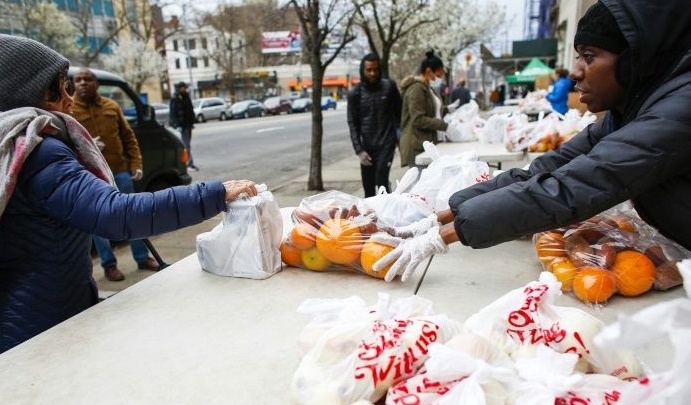 Volunteers from City Harvest food bank distribute food in Harlem, New York City. AFP