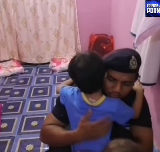 其中一名辛苦执勤的警员回到家中，拥抱自己的孩子。（Friends Of PDRM视频截图）
