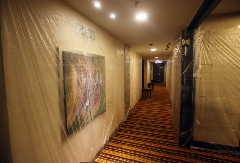 酒店走廊的墙壁上都被铺上塑料袋，以预防冠病在酒店内散播。