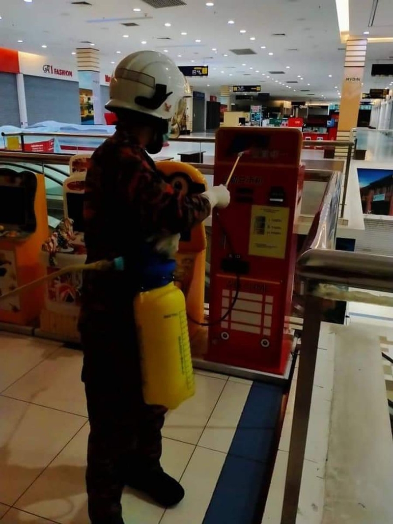 消拯员在数个超市内进行消毒。