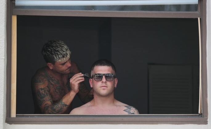 A man has his hair cut in his apartment as hair salons and barber shops are closed during the lockdown. AFP A man has his hair cut in his apartment as hair salons and barber shops are closed during the lockdown. AFP