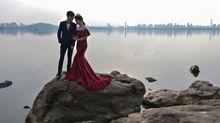 A couple pose for a wedding photo next to East Lake in Wuhan. AFP A couple pose for a wedding photo next to East Lake in Wuhan. AFP