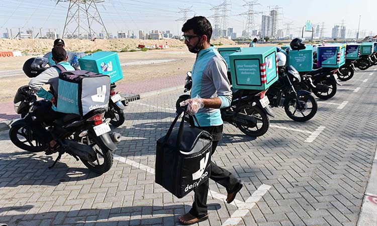 An employee of a delivery company prepares to leave for a job in Dubai. AFP An employee of a delivery company prepares to leave for a job in Dubai. AFP