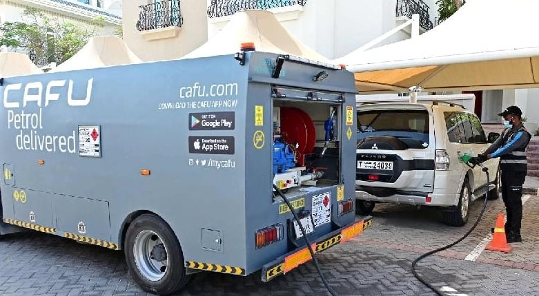Mullika Indy refills a car using a mini tanker outside a client's house in Dubai. AFP Mullika Indy refills a car using a mini tanker outside a client's house in Dubai. AFP