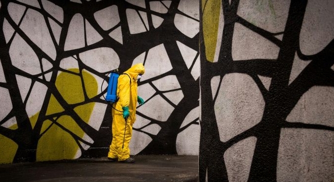 A worker in protective clothes disinfects a street in Bratislava, Slovakia. AFP A worker in protective clothes disinfects a street in Bratislava, Slovakia. AFP